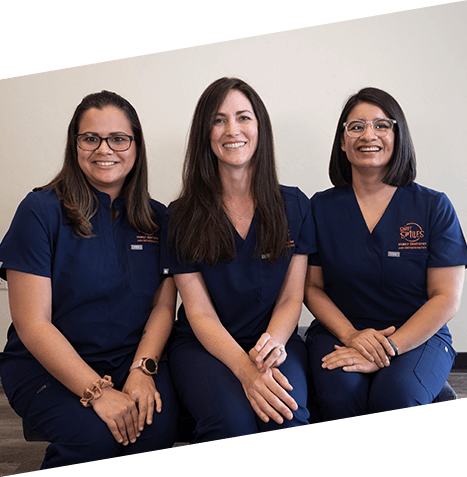 Three smiling Castle Rock dental team members