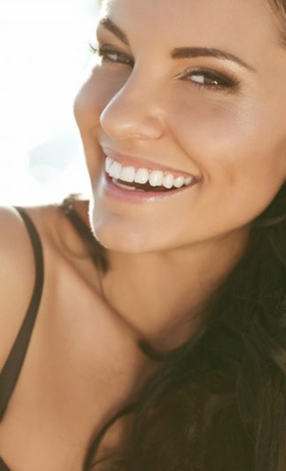 Woman smiling to reveal flawless teeth