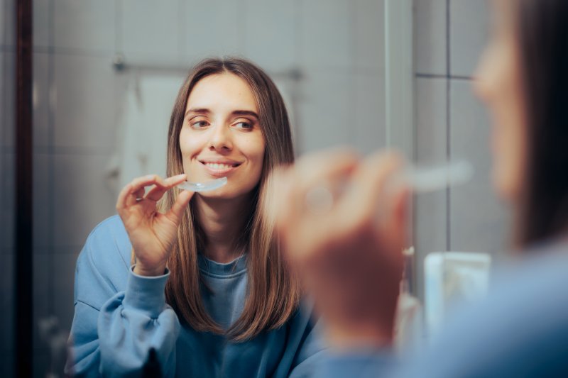 Patient smiling with their Invisalign aligners